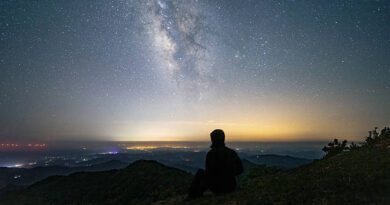 A man looking at the vast night sky.